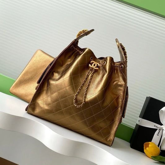 GABRIELLE BUCKET BAG IN METALLIC GOLD LAMBSKIN